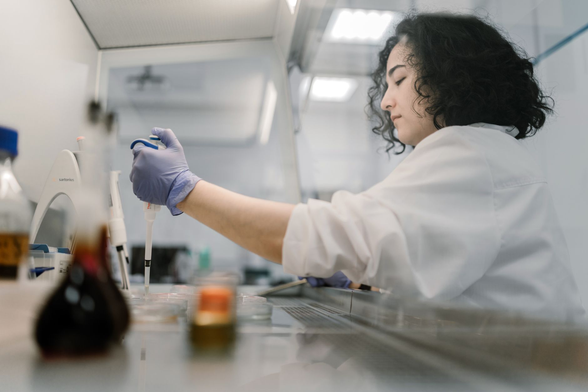 woman wearing laboratory gown doing experiment